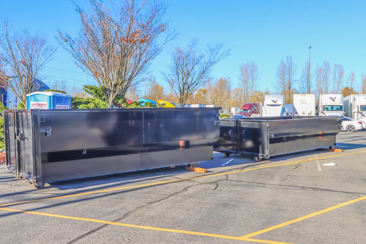 Professional dumpster rental service with roll-off container on residential driveway in Helotes
